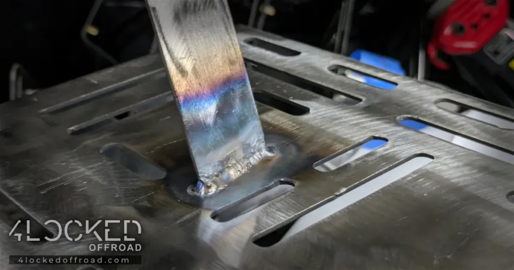 Close-up of TIG weld on 3rd Gen 4Runner ARB compressor mounting bracket showing weld bead and heat coloring on vertical support