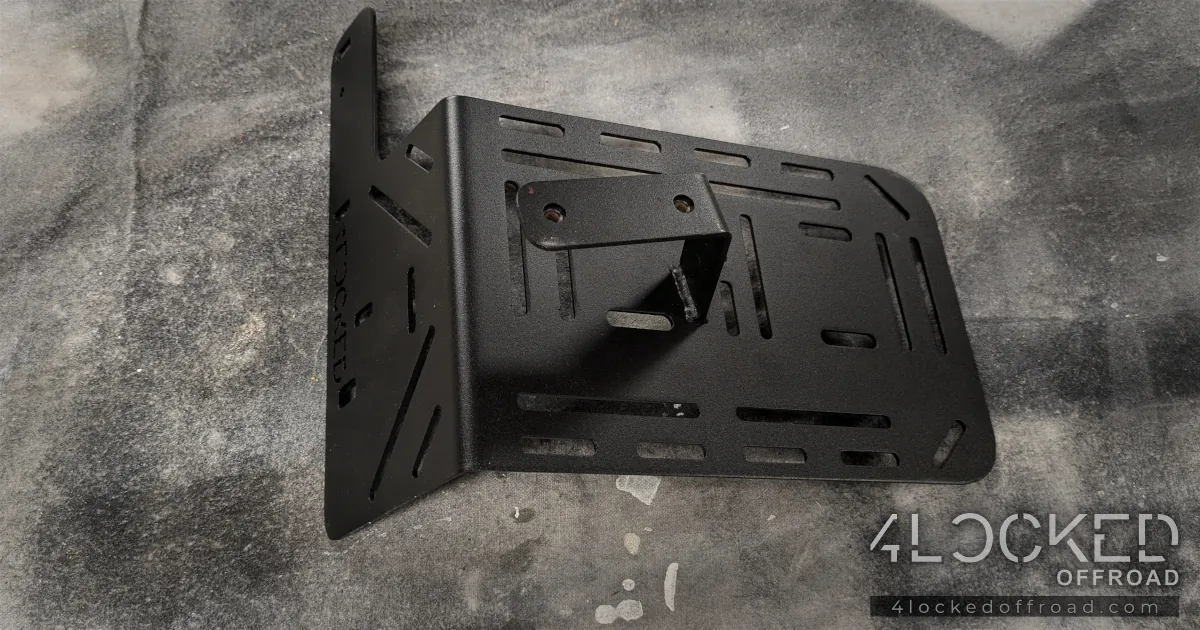 Underside view of the ARB compressor bracket showing the TIG welded compressor mounting tab.